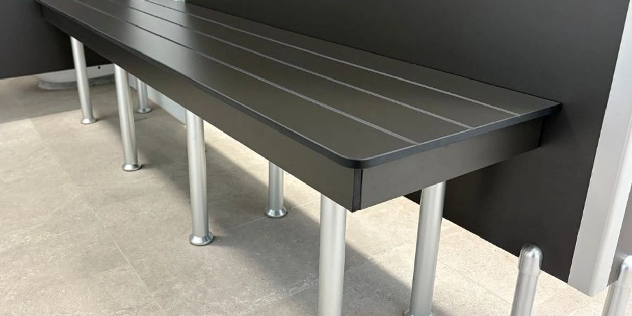 Modern black bench with metal legs.