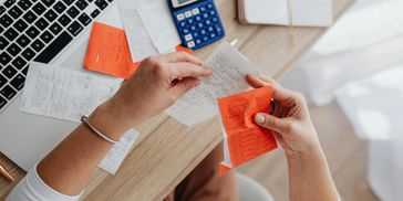 Person handling lots of receipts.