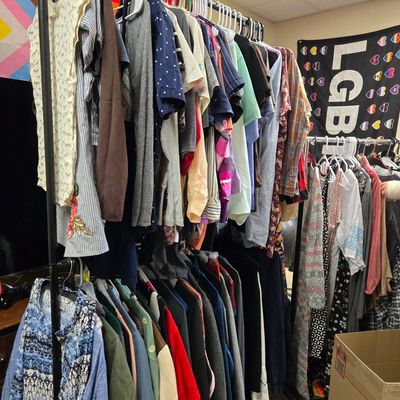 Photo of close on wheeled hangers at The Glass House for the Clothing Closet