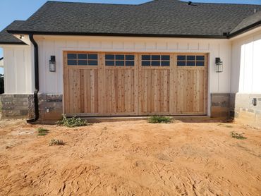 Custom wooden garage door residential installation with windows