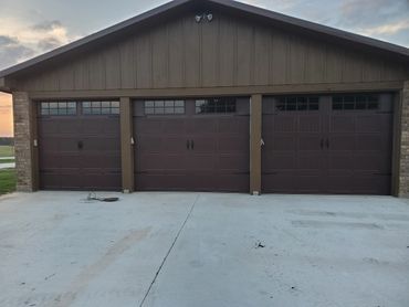 three car garage brown residential garage door installation with windows
