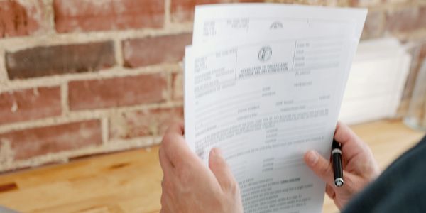 Attorney Matt Woods organizing court paperwork for signature with a client.
