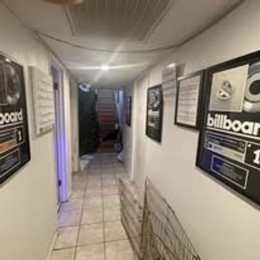 Hallway with framed Billboard awards on walls.