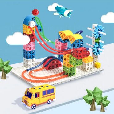 Colorful toy blocks with slides, a plane, and a school bus in a playful setup.