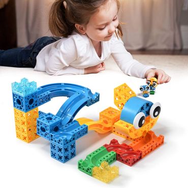 A girl playing with colorful building blocks creating a fun structure.