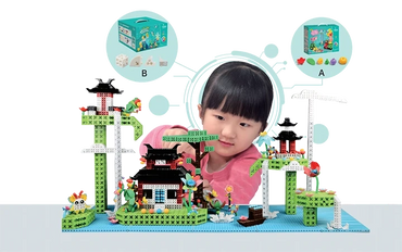 A girl building a colorful block model of a traditional house and trees.