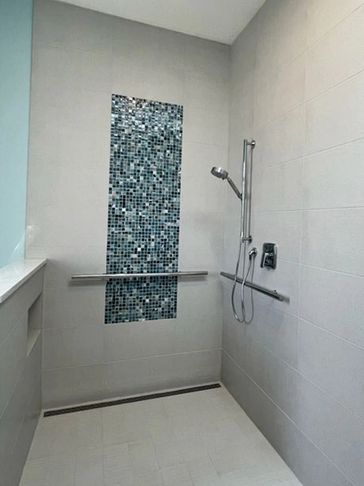 Clean modern style shower with glass mosaic insert.