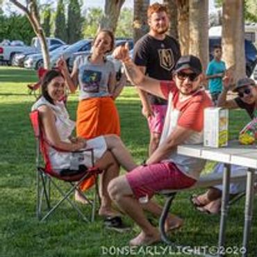 Group of friends enjoying a sunny outdoor gathering in the park.