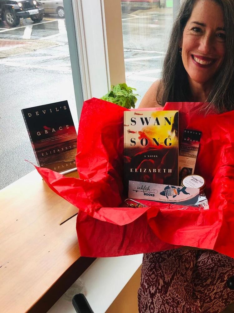 Splaine holding the Rhody Reader Box at Inkfish Books in Warren, Rhode Island.