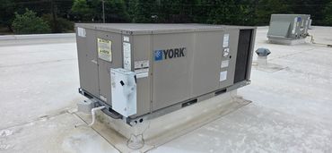 Commercial rooftop HVAC unit labeled YORK on a flat roof.