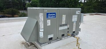 Commercial HVAC unit labeled American Standard on a rooftop.