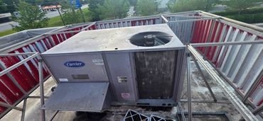 Outdoor Carrier HVAC unit on a rooftop with metal framing.