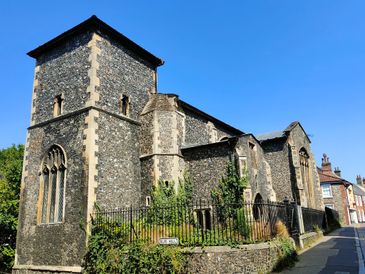 Historic stone church under a clear blue sky.