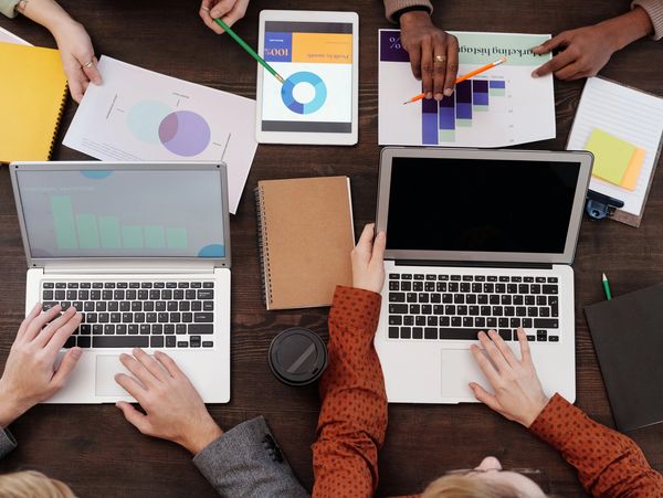 A desk with a team of people working