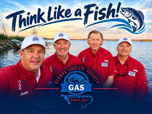 Four men wearing red shirts with a fishing theme backdrop and slogan.