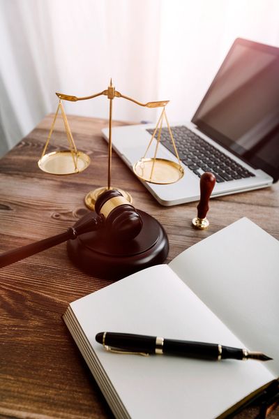 Law Book, Laptop and Brass Scale