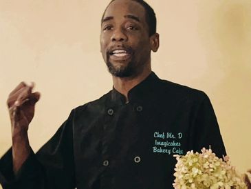 Chef Mr. D giving a presentation in a bakery cafe setting.