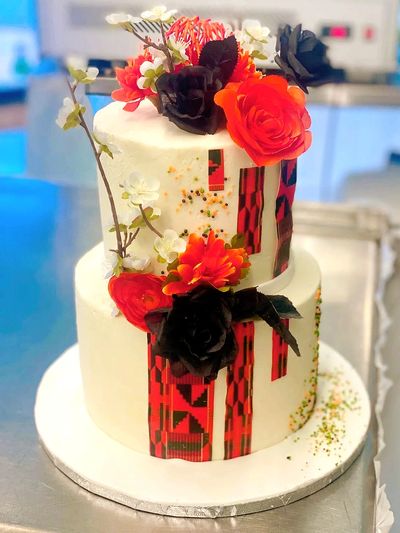 two tier cake with flowers and print design
