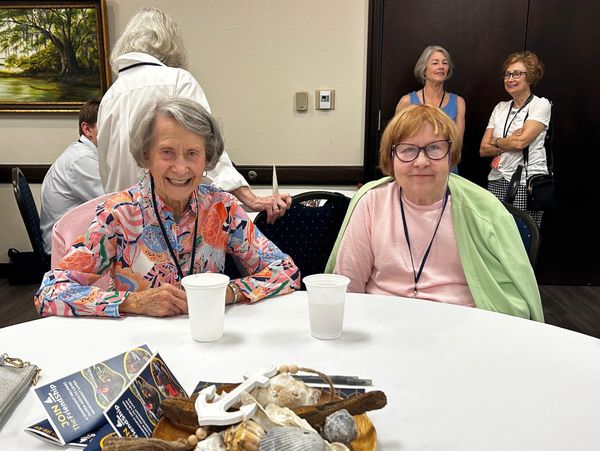 Two members sitting at a table together at the annual meeting