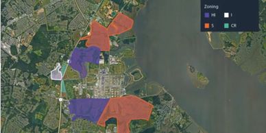 Map showing zoning areas with different color codes near a water body.