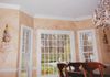 In this dining room, there's a three color stone glaze, on the walls, with topiaries, and scrolling detail.