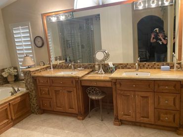 A spacious bathroom with dual sinks and a large mirror.