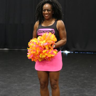 Fitness Cheerleader holding Weighted Pom Poms or PoundPoms