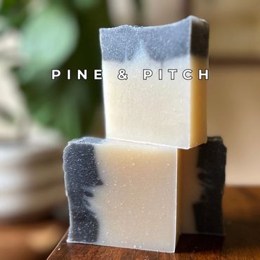 Handmade two-toned soap bars stacked, labeled Pine & Pitch.