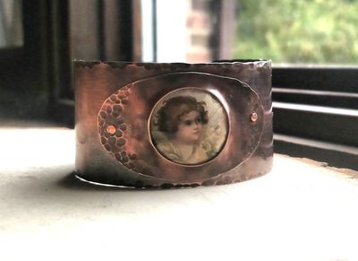 copper cuff made with a vintage tin with an image of an angel. $48