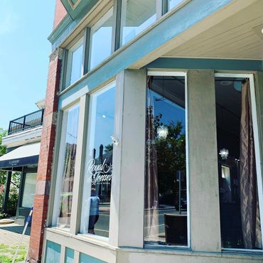 Corner view of Royal Tresses Hair Salon with large windows and reflections.