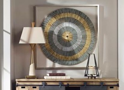 Rustic wooden cabinet with sliding black doors beneath decorative circular wall art.