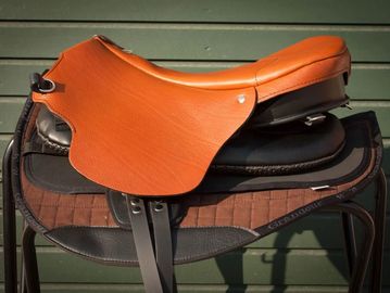 Close-up of a horse saddle on a stand.