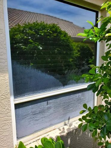 Before picture of hard water window stains on window that we cleaned