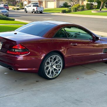 A maroon mercedes slk