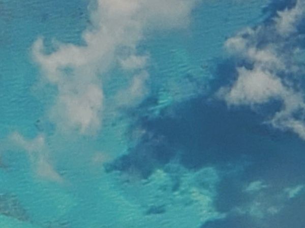 Clouds over a turquoise-blue sea