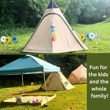 Colorful tents and a sandbox set up for family fun outdoors.