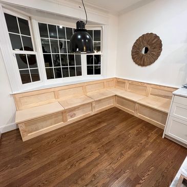 Newly built wooden corner seating in a dining nook.