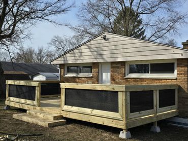 new deck with nylon privacy screen railing and a lake view