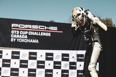 Race car driver celebrating at Porsche GT3 Cup Challenge Canada event.