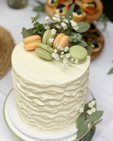 Elegant White Cake with Passion Fruit and Matcha Macarons