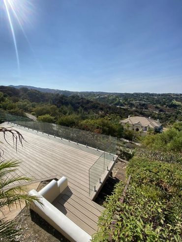 Client wanted to build a new deck with a glass railing and railroad stairs on the side of the deck.