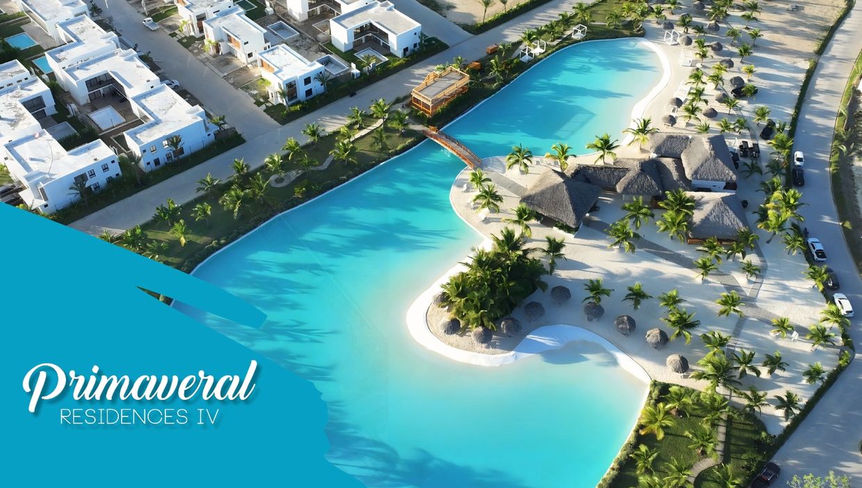 Aerial view of Primaveral Residences IV with blue lagoon and white residences.
