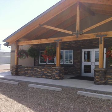 Entrance of a building with wooden beams and stone accents.