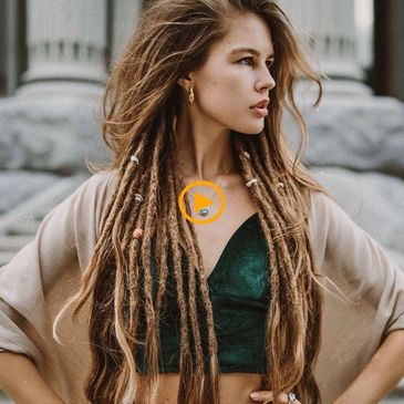 Person with long blonde hair and brown synthetic dreadlock extensions at a salon offering Dreadlocks