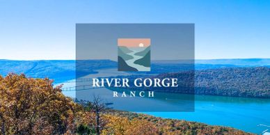 Scenic view of River Gorge Ranch with lake and hills.
