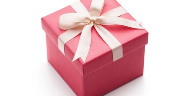 Pink present wrapped with white ribbon to denote brand packaging and strategy.