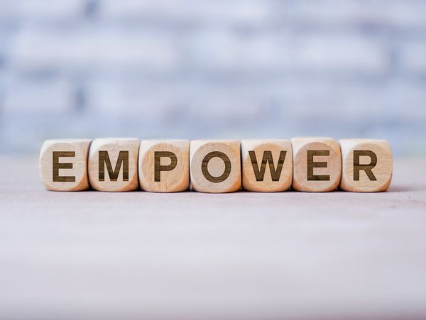 Empower word written on wood block