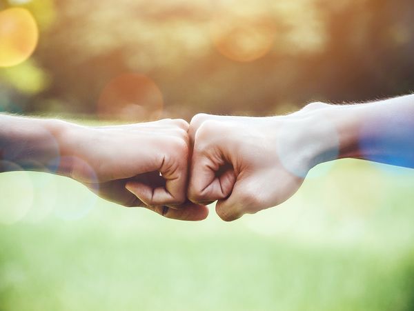 Hands of two man people fist bump team teamwork and partnership business success