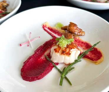 Scallop on a plate with radish in milwaukee for a corporate event