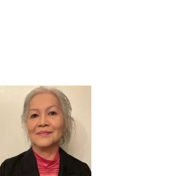 A photo of the founder and CEO of the company in a black blazer and red shirt.